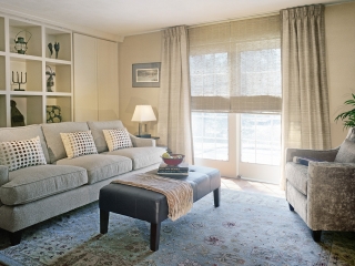transitional interior design window treatment showing woven shade and leather banded drapery