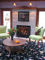 Fireplace with raw marble surround by Boston Design and Interiors, Inc.